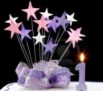 4315699-fancy-cake-with-number-one-candle--decorated-with-ribbons-and-star-shapes-in-pastel-tones-on-black-b